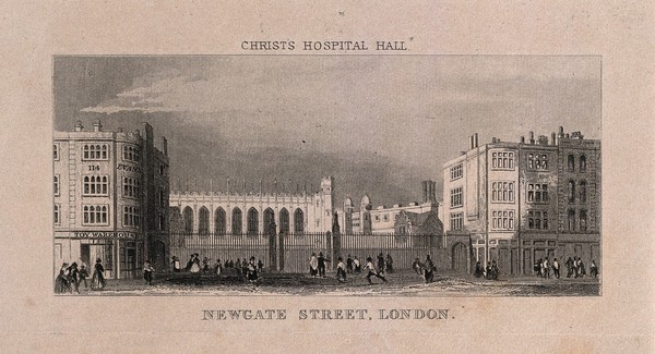 This image is an engraving of a building in black ink on an off-cream background. In front of the building is a slatted fence that sits between two buildings on each side that are four storeys high. In front of the fence is a street with people milling about. The central building sits back from the fence and looks similar to a church with multiple high arches running along its side. Above the etching are the words: CHRIST’S HOSPITAL HALL. Below the etching are the words: NEWGATE STREET, LONDON.