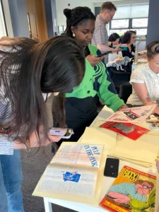 Delegates browsing the magazines at the Activist Legacies Roundtable May 2024