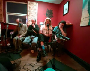 Project lead Richard O'Brien interviews local songwriters Nev Clay and NOVYI LEF band members Thomas Reah and Euan Lynn, at Baba Yaga's Loft for 'Songwriters in Conversation #1: Writing the Modern City. January 2025.