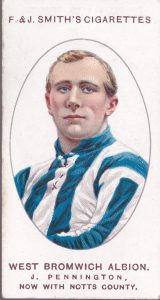 Full colour football cigarette card with head and shoulders portrait of West Brom player Jesse Pennington, looking thoughtfully into the middle distance, arms folded, in a blue and white striped jersey.